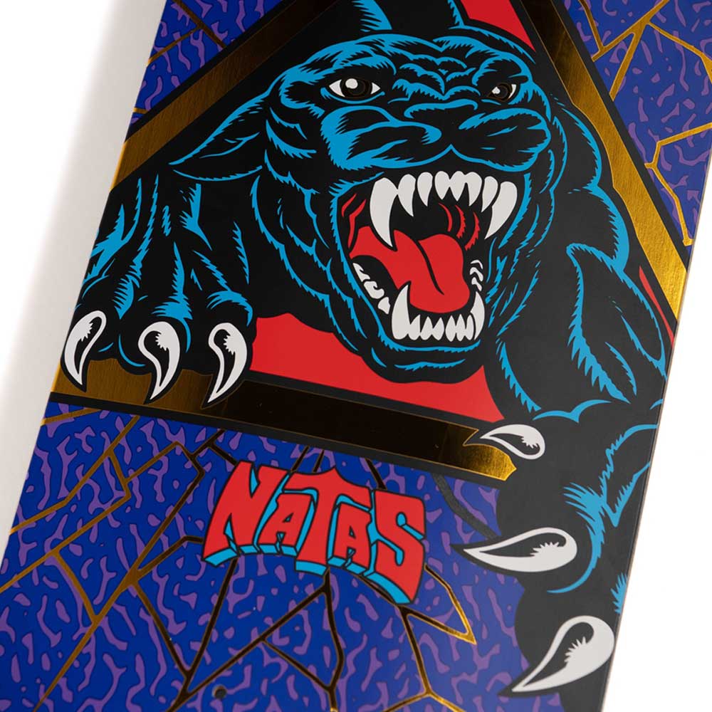Here is a rewritten version of your sentence using the provided product data: Close-up of the Natas Shattered Panther VX Deck 9.00in x 32.15in from Santa Cruz Decks, showcasing a graphic of a snarling black panther with extended sharp claws and bold red “NATAS” lettering on a blue and gold patterned background.