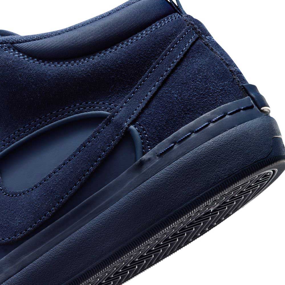 Close-up of the heel and side of the Navy Black IR1889400 Leo Baker React Nike SB Suede Leather Skateboarding Shoes, highlighting detailed stitching, suede and smooth textures, plus a rubber sole with geometric tread for traction.
