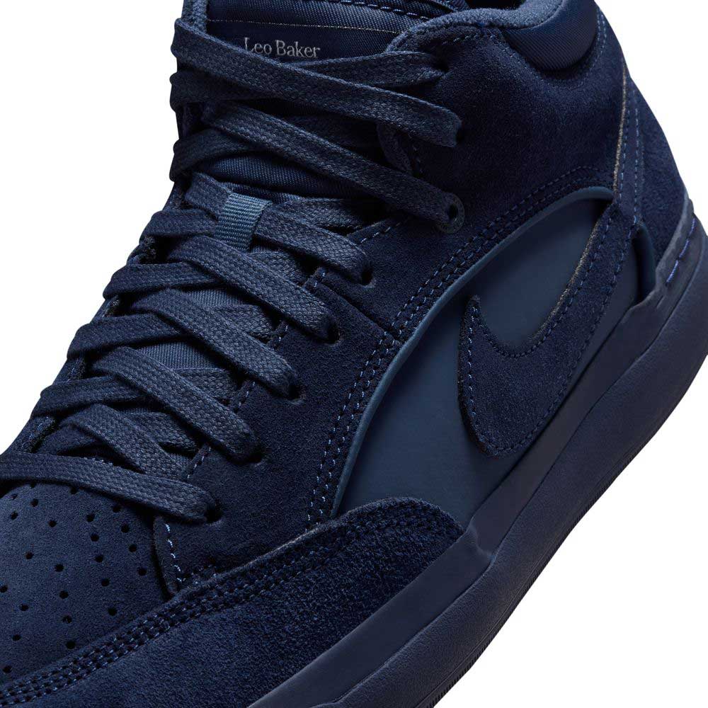 Close-up of Navy Black IR1889400 Leo Baker React Nike SB Suede Leather Skateboarding Shoes, showing detailed laces, suede/leather textures, embroidered Swoosh, Leo Baker name near ankle collar, and durable traction with a broken-in feel for skating.