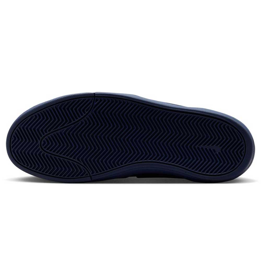 The image shows the navy black sole of the Nike SB Leo Baker React IR1889400 skateboarding shoe with a herringbone tread, photographed from below to highlight its durable traction against a white background.