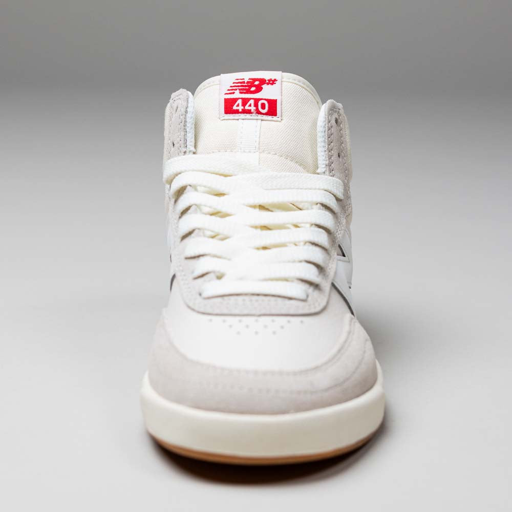 The 440 HTW Timberwolf White New Balance Numeric Suede Skateboarding Shoe is shown from the front, with durable white laces and a red tongue label featuring the New Balance logo and "440" in white text.