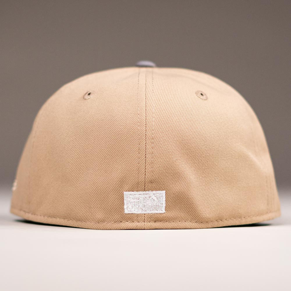 A Chalino Skull Camel Storm Houston Astros New Era 5950 Fitted Hat in beige, seen from the back with a small white rectangular patch near the bottom center against a plain, neutral background.