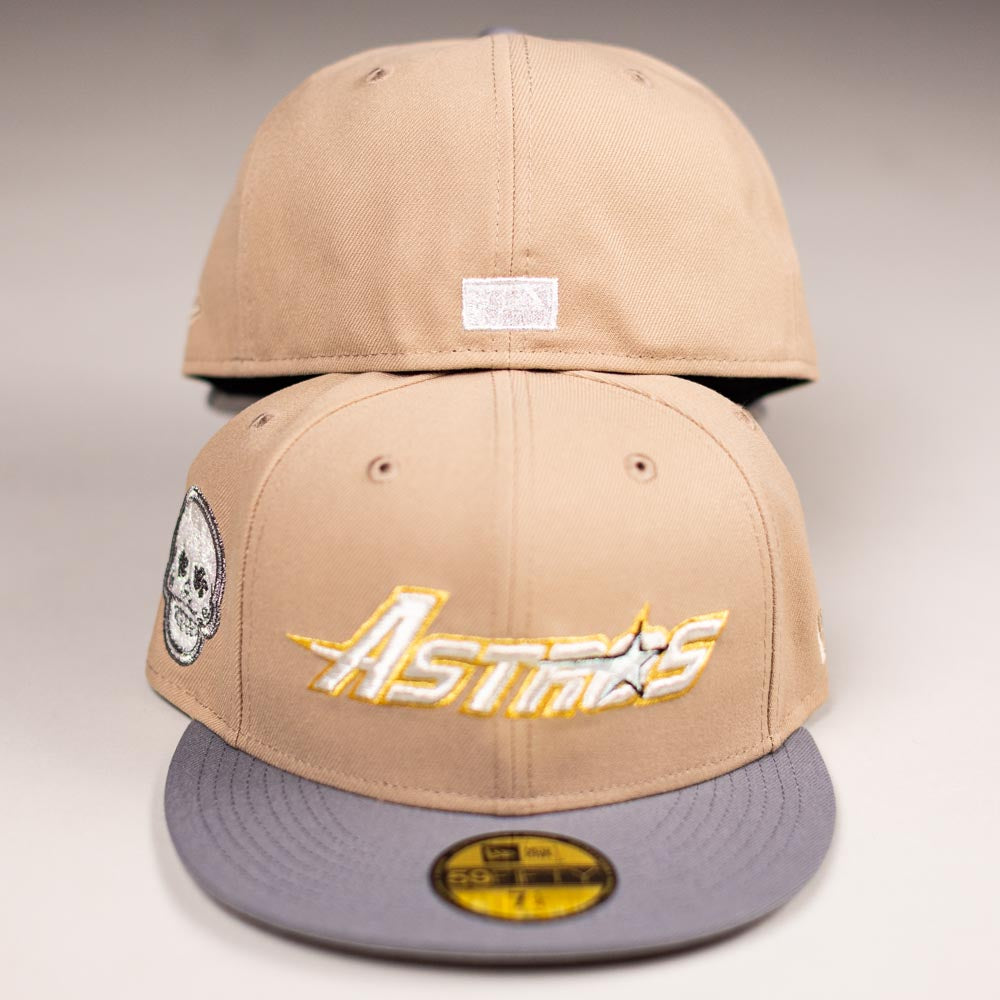 Two Chalino Skull Camel Storm Houston Astros New Era Hat 5950 Fitted caps are shown. The front cap has “Astros” in yellow/white with a star, grey brim, and a Chalino Skull patch; the back cap shows a small white patch.