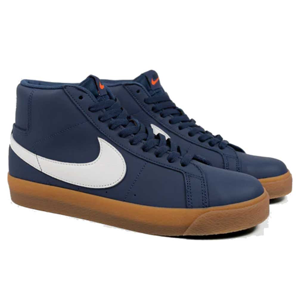 The Nike SB Blazer Mid FJ1680400 White Navy Leather Shoes feature a navy and white design, brown gum soles, and Zoom Air cushioning. Shown side by side on a white background.