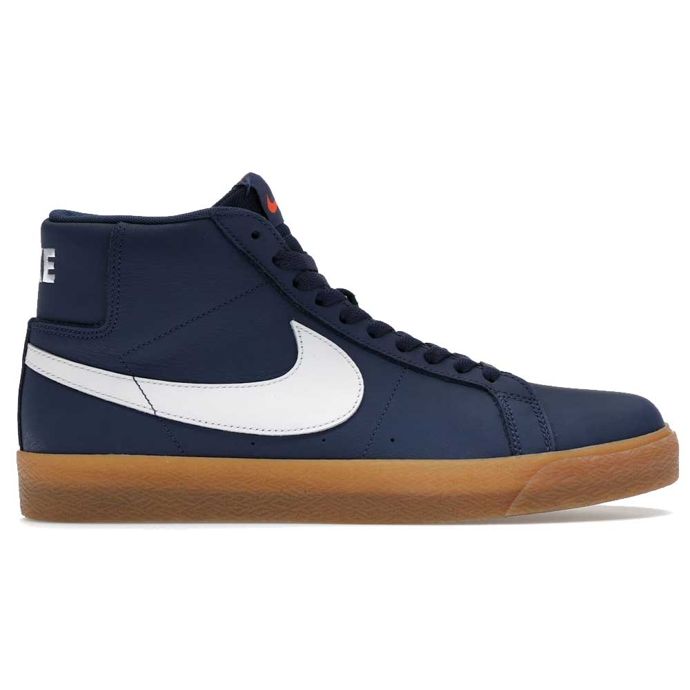 The Nike SB Blazer Mid FJ1680400 White Navy Leather Shoes feature a navy leather high-top design with a white swoosh, black laces, orange tongue branding, white NIKE heel text, gum sole, and Zoom Air cushioning for skateboarding.