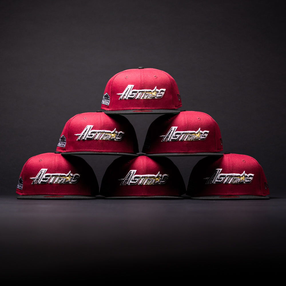 Six Bloodline OG Cardinal Red Houston Astros New Era Hat 5950 Fitted caps are arranged in a pyramid shape against a dark background, each displaying the Astros logo.
