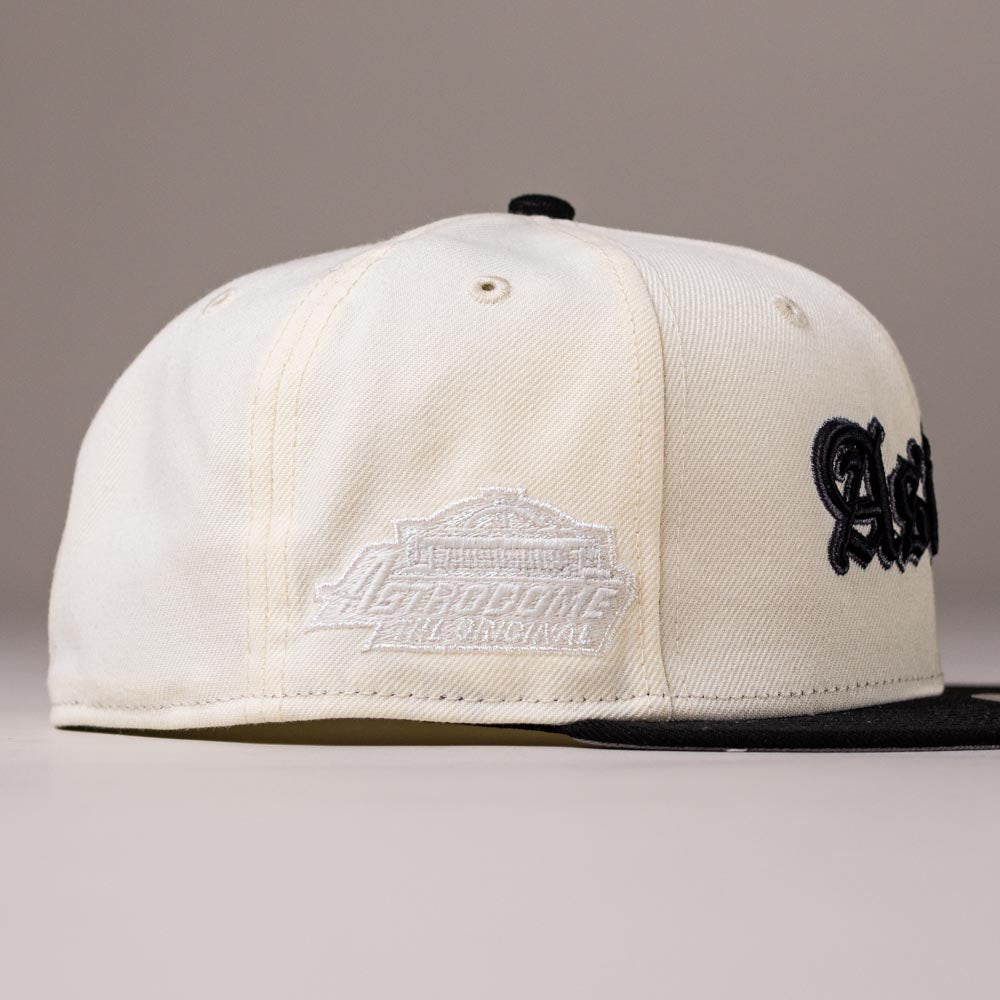 Introducing the Straight Outta Southside OG Chrome Black Houston Astros New Era Hat 5950 Fitted—a cream-colored fitted cap by New Era featuring a bold black brim, embroidered lettering, and a stadium design patch on the side, perfect for devoted Houston Astros fans.