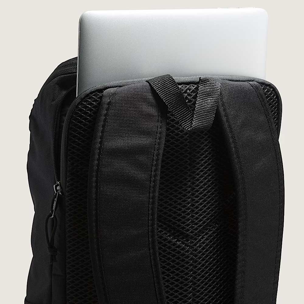 A close-up of the Obstacle Skatepack Backpack VN0A3I696ZC1 Black Ripstop by Vans Skateboarding shows a laptop in the back compartment, with padded shoulder straps and mesh padding for comfort.