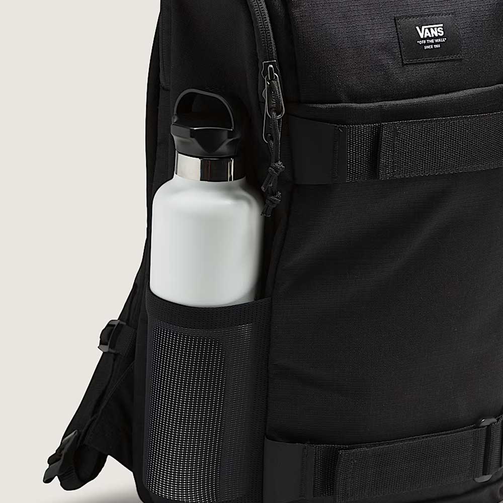 A close-up of the Obstacle Skatepack Backpack VN0A3I696ZC1 Black Ripstop by Vans Skateboarding, featuring a white stainless steel water bottle in the mesh side pocket, zippered main compartment, and visible logo label.