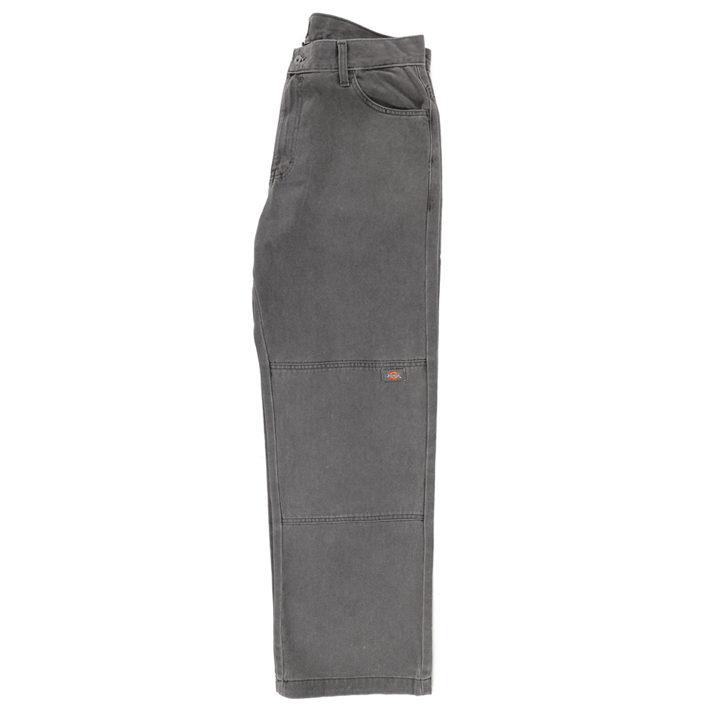 The P415259 Loose Double Knee Woven Denim Jean in Grey Wash Tinted by Dickies Skateboarding features a relaxed fit, two front pockets, a coin pocket, and a logo patch on the thigh, shown flat on a white background.