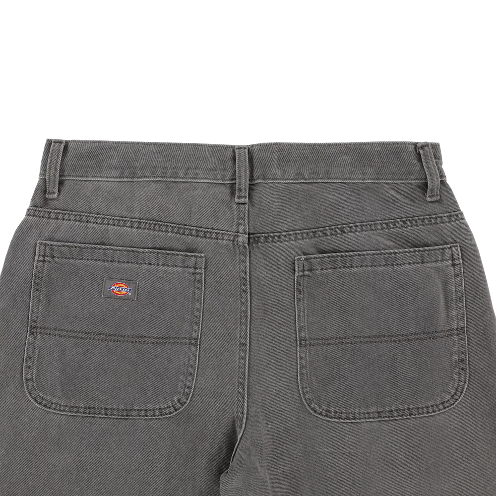 Back view of the P415259 Loose Double Knee Woven Denim Jean in Grey Wash Tinted by Dickies Skateboarding, featuring two large rear patch pockets with a small Dickies logo on the left and visible belt loops.