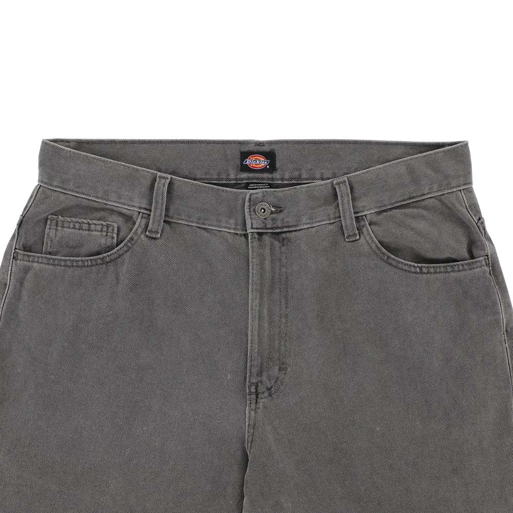 A close-up of the waistband and top of the P415259 Loose Double Knee Woven Denim Jean Grey Wash Tinted by Dickies Skateboarding, featuring belt loops, a button closure, front pockets, and a visible inner waistband brand label.