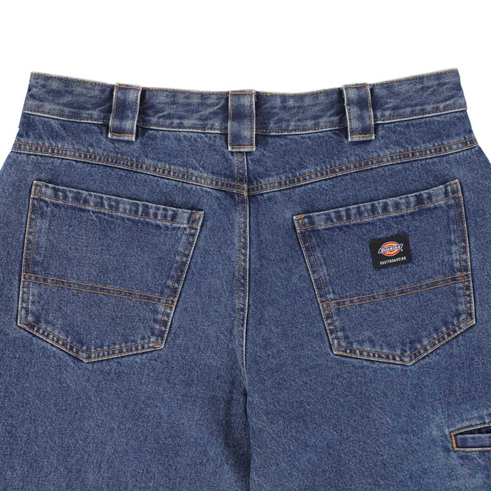 Close-up of the P415316 Mike Anderson Stonewashed Denim Jean from Dickies Skateboarding: blue denim, loose fit, two large back pockets with a small Dickies label, classic yellow stitching, belt loops, and a slightly faded texture—ideal for skateboarding style.