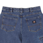 Close-up of the P415316 Mike Anderson Stonewashed Denim Jean from Dickies Skateboarding: blue denim, loose fit, two large back pockets with a small Dickies label, classic yellow stitching, belt loops, and a slightly faded texture—ideal for skateboarding style.