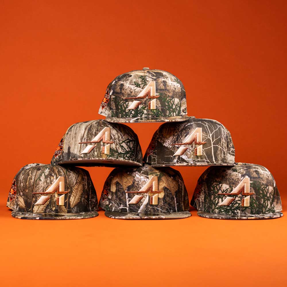 Six Panhandle Real Tree Orange Houston Astros New Era Hat 5950 Fitted caps, each with an orange and white Astros A logo, are displayed in a pyramid against an orange background.