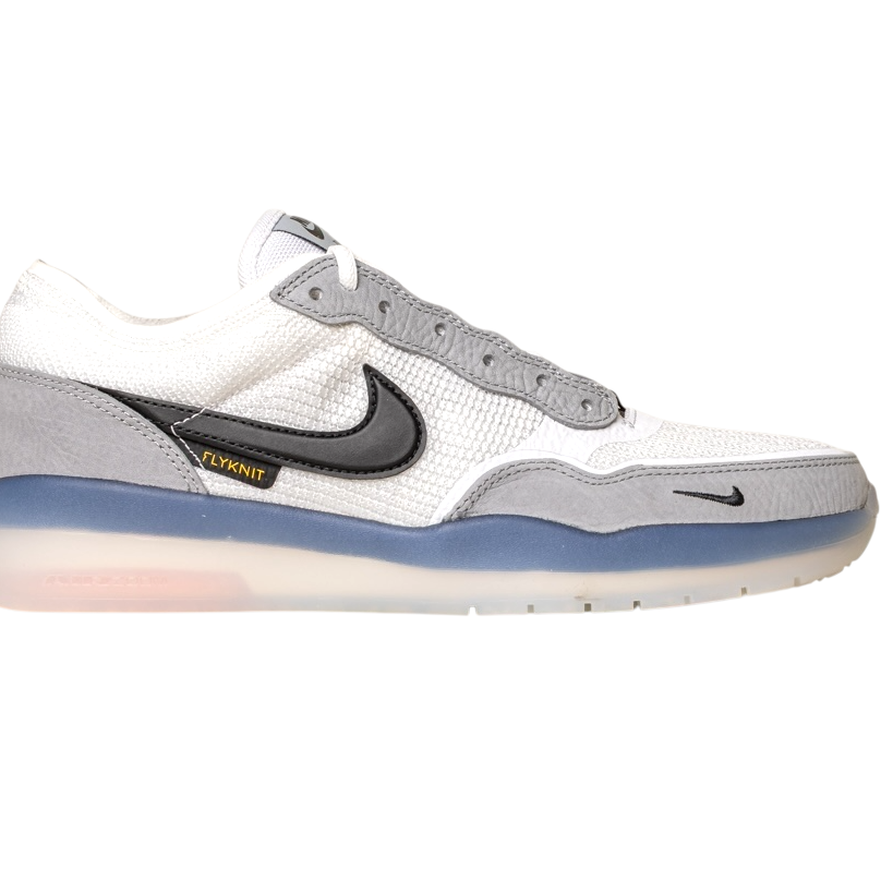 The FV8493004 Grey White PS8 Nike SB Leather Knit Shoes feature a white and gray design, black swoosh, gray suede details, mesh upper, translucent blue and white sole, and a small yellow "Flyknit" tag near the swoosh.