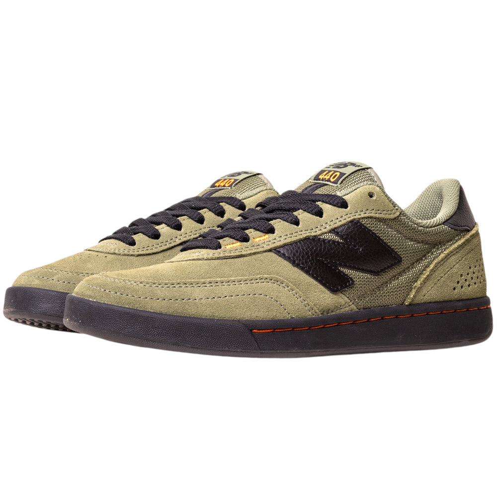 The 440NL2 Dark Olivine Black New Balance Numeric Suede Skateboarding Shoes feature an olive green suede upper, black laces, black ‘N’ logo, black soles, orange accents, a low-top casual design, and a comfy ABZORB midsole.
