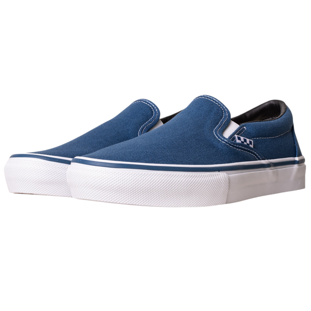 The VN0A5FCANVY1 Navy Skate Slip On Vans Canvas Shoes feature blue canvas uppers with DURACAP reinforcement, white rubber soles, and stitching, showcased on a white background.