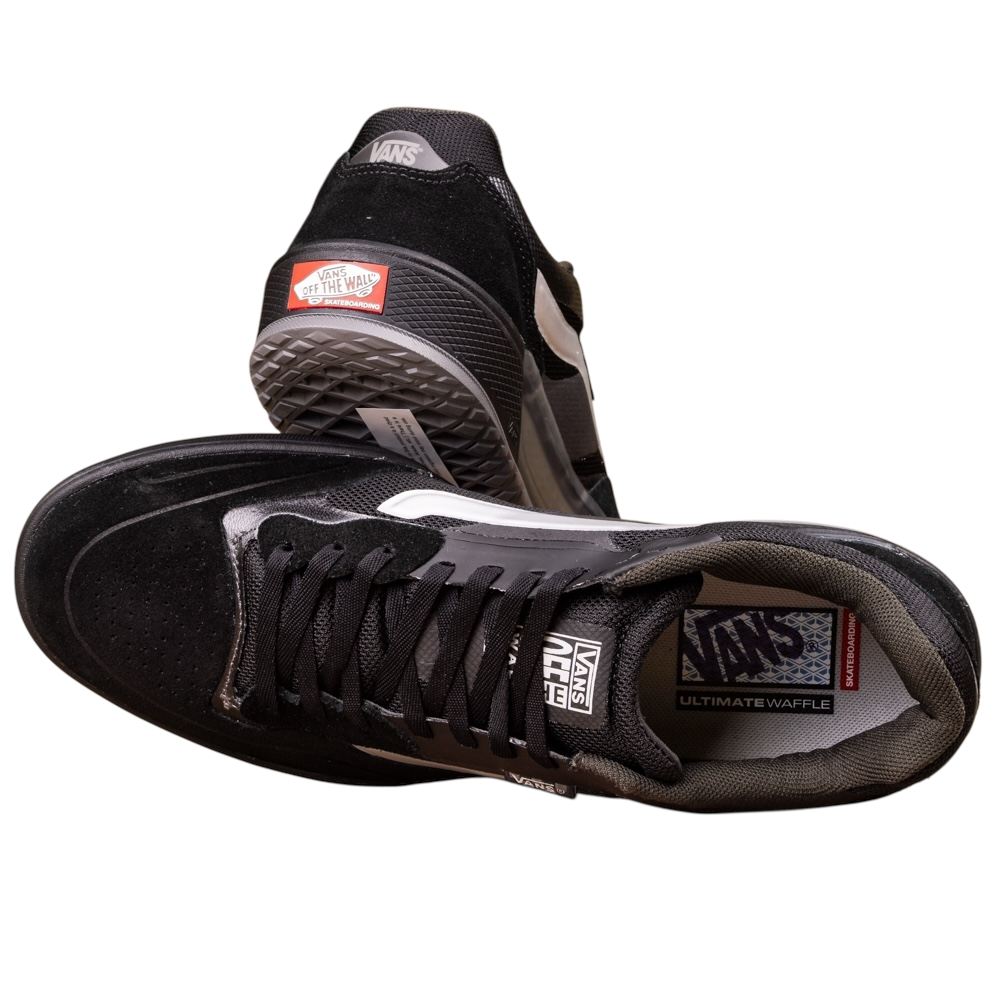 The VN000DA1B5T1 Black Metallic Skate Ave 2.0 Vans Suede Skateboarding Shoes feature one shoe on its side showing the sole and another upright with visible logo and laces—ideal for high-performance skateboarding.