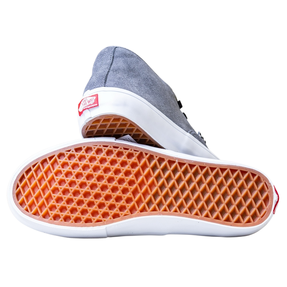 A pair of Skate Authentic Mid Vans VN000EJSPWT1 Pewter Suede skateboarding shoes, one upright and one showing the orange waffle-patterned outsole, white midsole, and red heel logo tag, set against a plain white background.