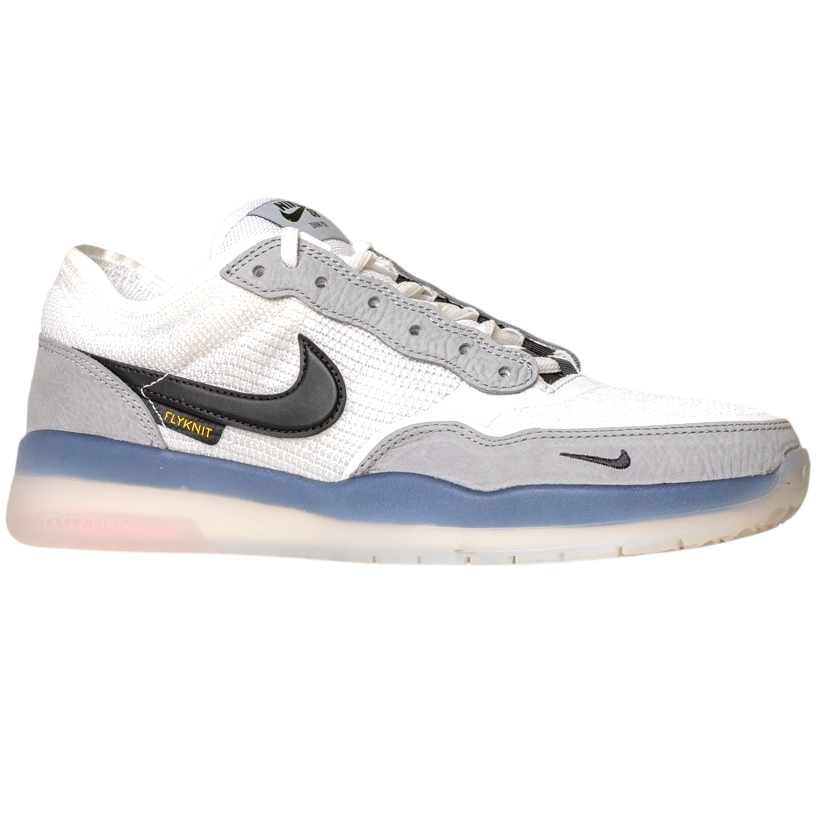 The FV8493004 Grey White PS8 Nike SB Leather Knit Shoes feature a white and gray design, black swoosh, blue-tinted translucent sole, gray suede accents, yellow VNKIT detail, and Air Zoom cushioning for comfort.