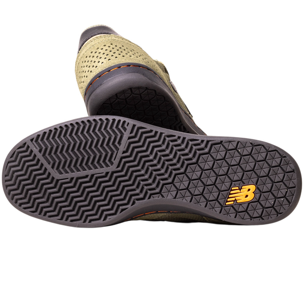 Close-up of the 440NL2 Dark Olivine Black New Balance Numeric suede skateboarding shoe shows a black treaded sole with a yellow NB logo near the heel and an olive green perforated upper for stylish breathability.