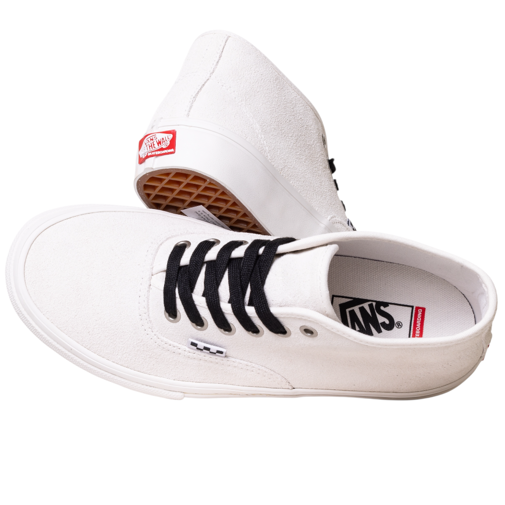 The VN000EJSJVY Blanc de Blanc Authentic Mid Vans Skate Suede Shoes feature a white canvas upper with black laces. One shoe is shown top and side view, the other on its side displaying the waffle-patterned sole and red Vans heel logo.