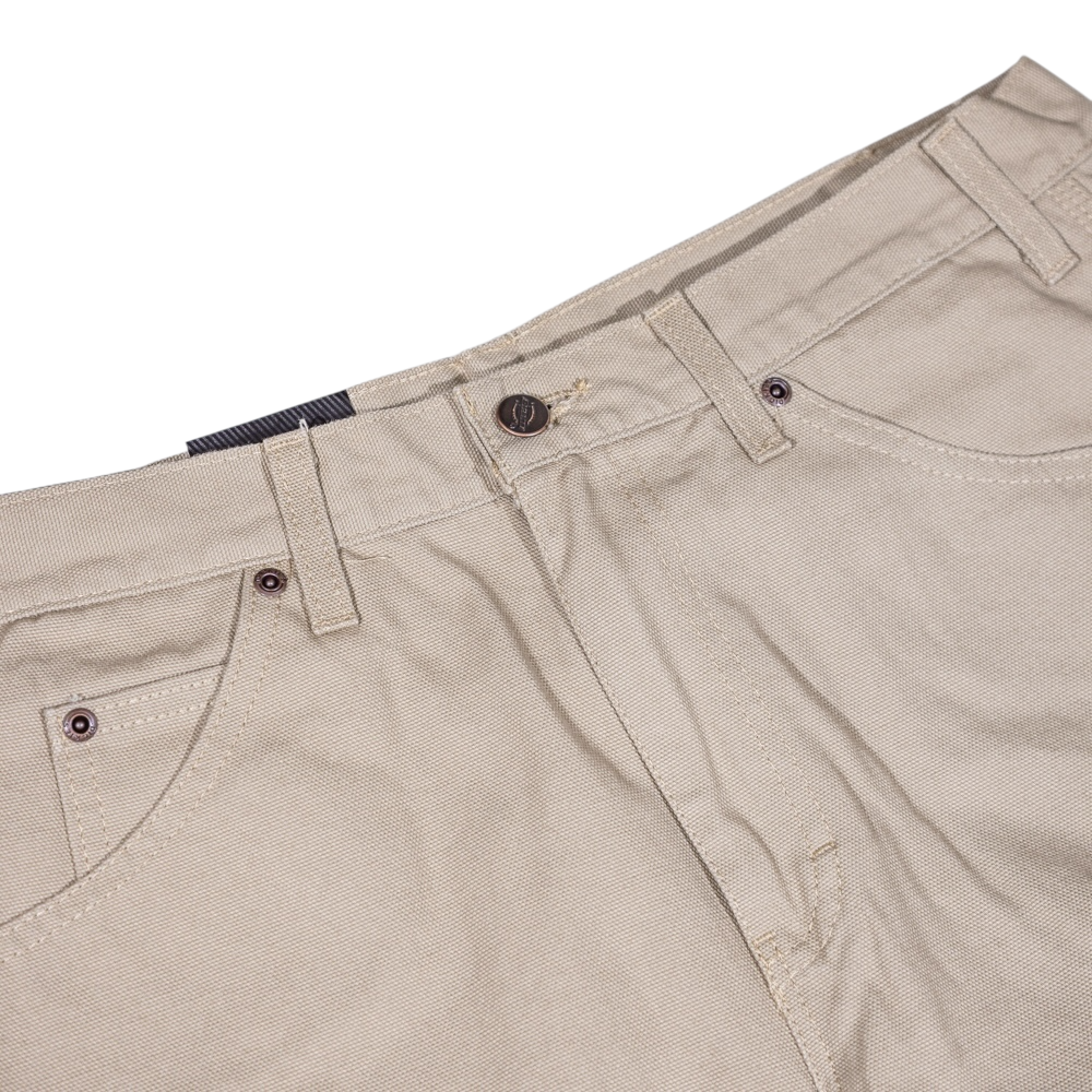 The 1939 Rinsed Desert Sand Duck Relaxed Utility Jean Denim Pant by Dickies Skateboarding features front pockets, belt loops, and a button closure. These relaxed fit carpenter pants offer classic style and durability, perfect for men’s workwear.