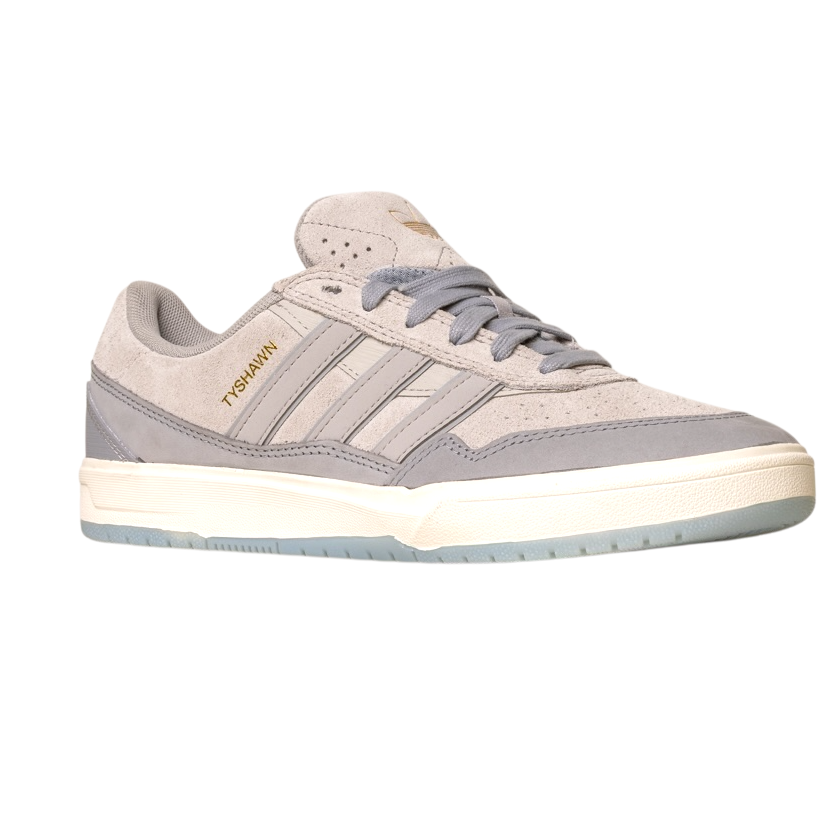 The JI0848 Granite White Tyshawn 2 II Adidas Skateboarding Shoe features gray and beige suede, three side stripes, a white midsole, TYSHAWN in gold, a light blue outsole, and is part of the Tyshawn II collection.