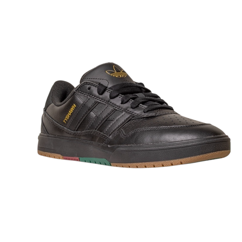 The Tyshawn 2 II Adidas Skateboarding Core Black/Core Green Leather Shoes feature gold Handball text, a black tongue with the gold Adidas logo, black laces, and a brown rubber sole with red and green accents.