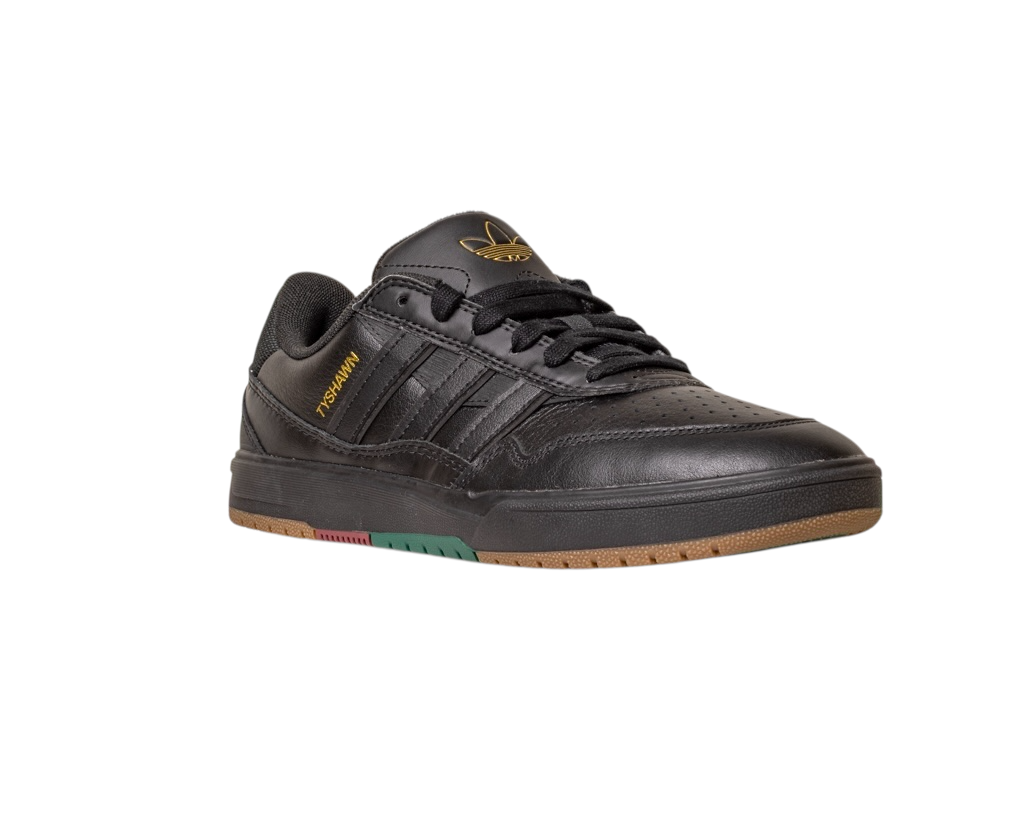 The Tyshawn 2 II Adidas Skateboarding Core Black/Core Green Leather Shoes feature gold Handball text, a black tongue with the gold Adidas logo, black laces, and a brown rubber sole with red and green accents.