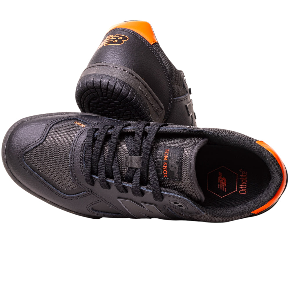 The 600TOO Black Orange Tom Knox New Balance Numeric Leather Skateboarding Shoes feature mesh and leather uppers, Ortholite insoles, and responsive FuelCell foam, shown from the side and top with bold orange accents.