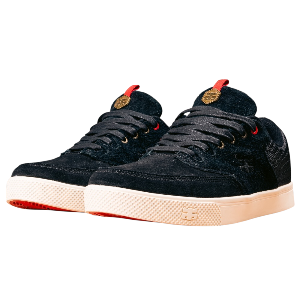 The Poet Black Suede Ballistic Nylon I Path Skateboarding Shoes feature black low-top design, textured ballistic nylon uppers, cream rubber soles, red accents, and gold logo details on the tongue; shown side by side facing left.