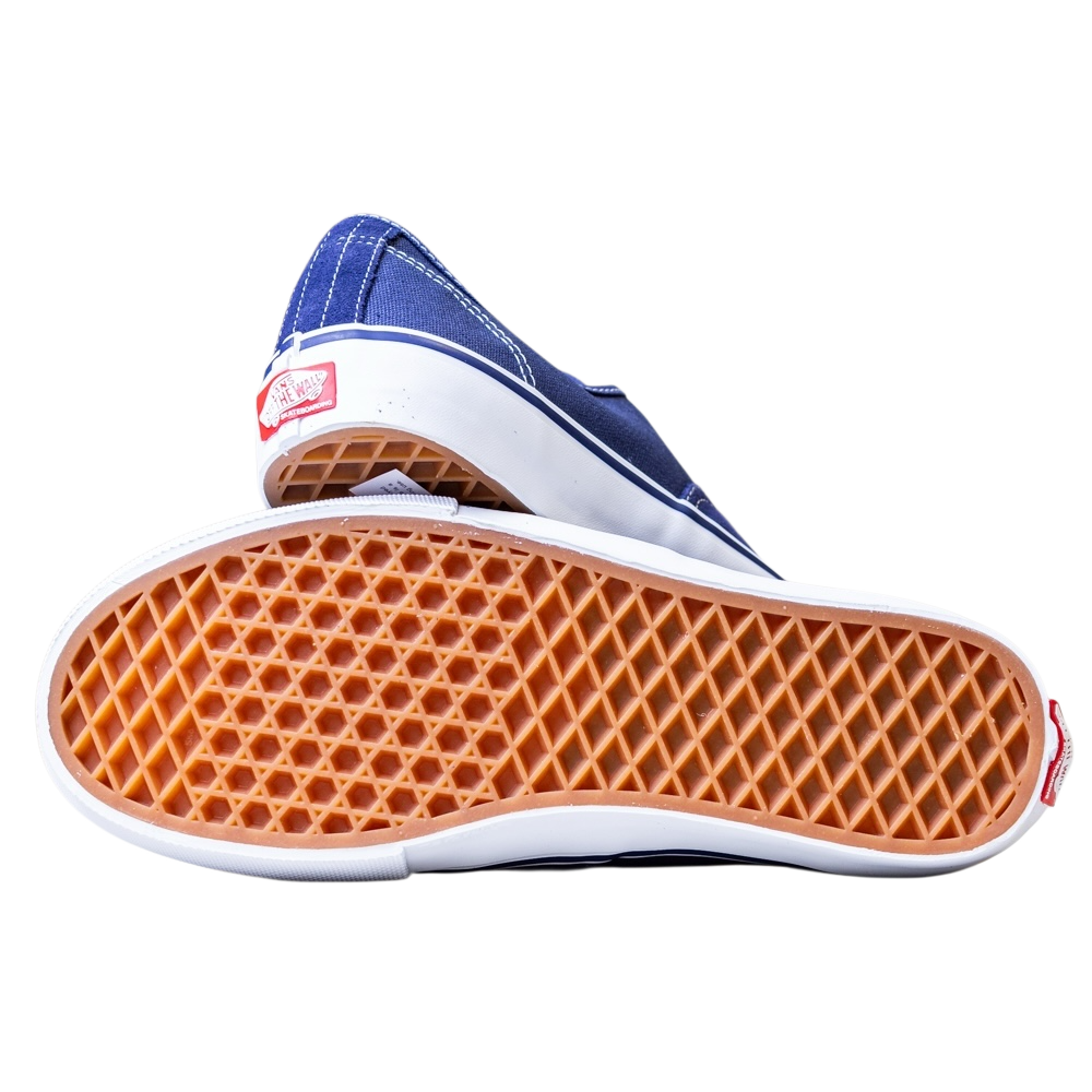 A pair of Skate Authentic Deep Twilight Vans VN000EEREMT1 Suede White Skateboarding Shoes, one on its side and the other showing the waffle-patterned sole—classic, durable suede skate shoes ideal for everyday style.