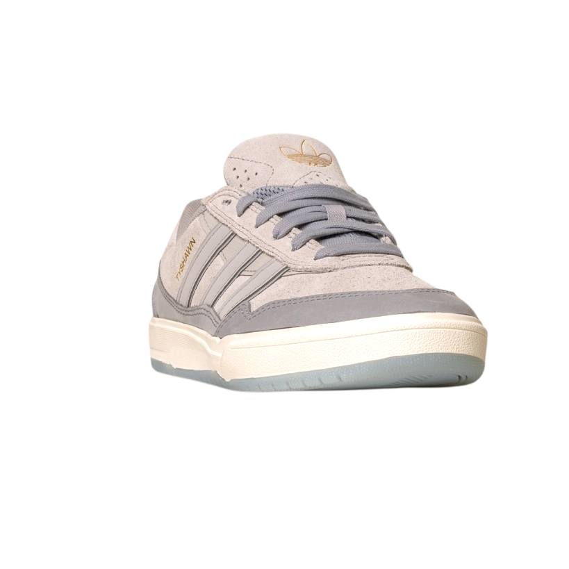 The JI0848 Granite White Tyshawn 2 Adidas Skateboarding Shoe is shown facing forward on a white background, featuring gray laces, a gum sole, and the Adidas logo on the tongue. The upper is crafted from leather and suede.