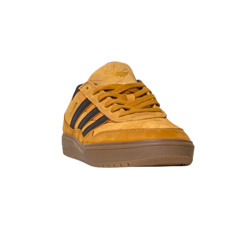 The JI0851 Mesa Black Gum Tyshawn 2 Adidas skateboarding shoe features mustard yellow leather and suede with black stripes, a brown cupsole, and is shown from a front angled view on a white background.