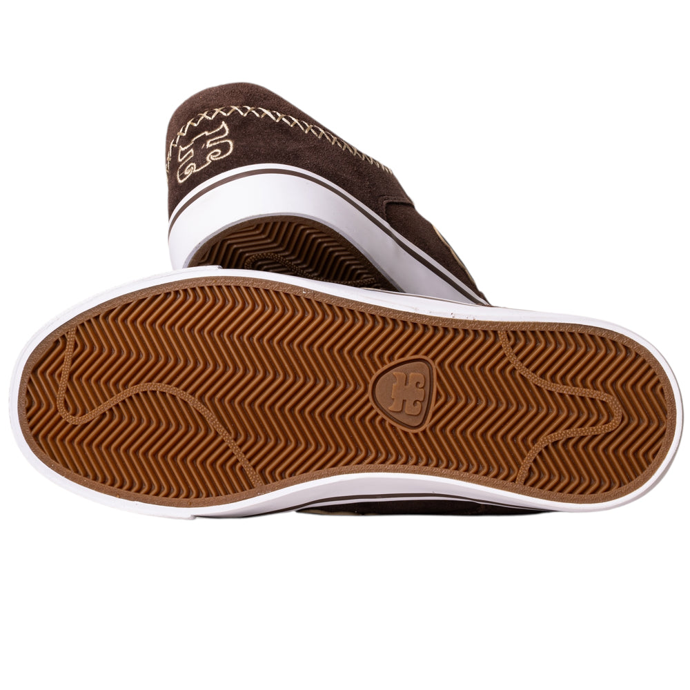 A pair of Kenny Reed Low Vulc Brown Suede I Path skate shoes: one lies on its side showing the tan rubber logo sole, the other stands behind it. Both feature white soles and classic skateboarding style.
