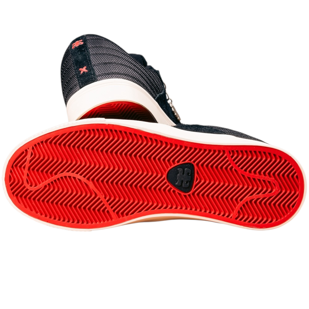A close-up of the Poet Black Suede Ballistic Nylon I Path Shoes Skateboarding shows a bright red textured sole with a black logo by the arch, while the upper combines durable Ballistic Nylon, dark tones, and red stitching detail.
