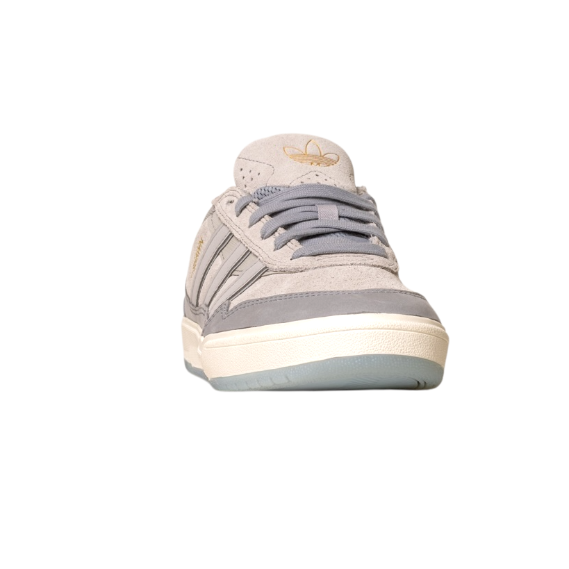 The JI0848 Granite White Tyshawn 2 II Adidas Skateboarding Leather Suede Shoe, shown from the front with a rubber sole, gray laces, and gold Adidas logo on the tongue, is ideal for fans of Adidas Skateboarding Shoes, set against a white background.