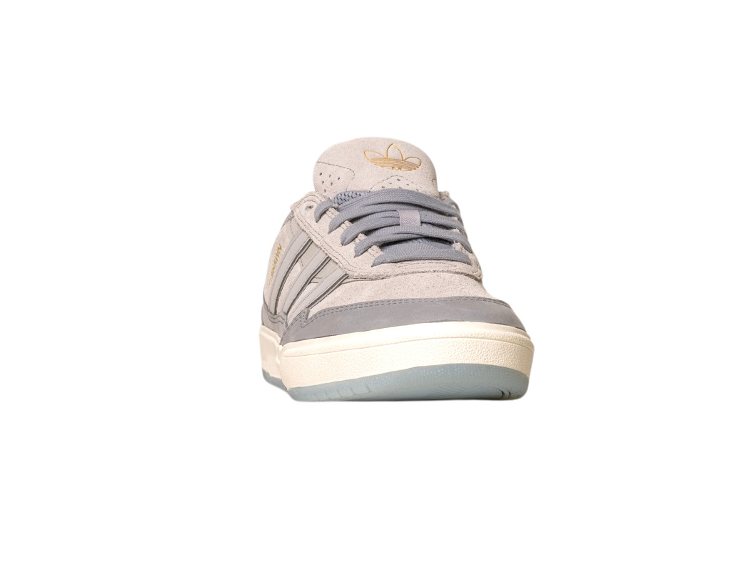 The JI0848 Granite White Tyshawn 2 II Adidas Skateboarding Leather Suede Shoe, shown from the front with a rubber sole, gray laces, and gold Adidas logo on the tongue, is ideal for fans of Adidas Skateboarding Shoes, set against a white background.