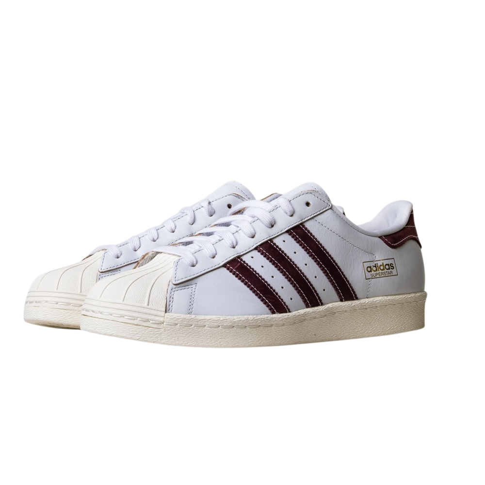 A pair of JP8529 Cloud White Share Superstar 80 ADV Adidas skateboarding leather shoes with maroon stripes, gold branding, and off-white shell toes and soles, displayed side by side on a white background.