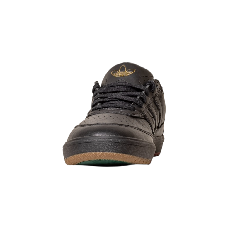 The Tyshawn 2 II Adidas Skateboarding Core Black/Core Green leather shoe features black laces, a gold Tyshawn II logo on the tongue, and a brown and green sole, shown from the front on a white background.