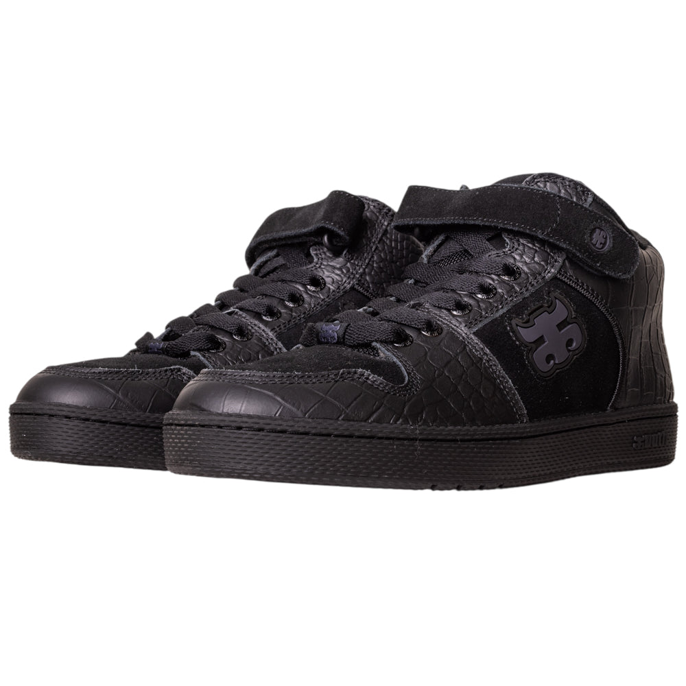 The Grasshopper Black Croc Leather I Path Skateboarding Shoes feature textured black croc leather, lace-up fronts, a velcro strap, large side logo, and black rubber soles.