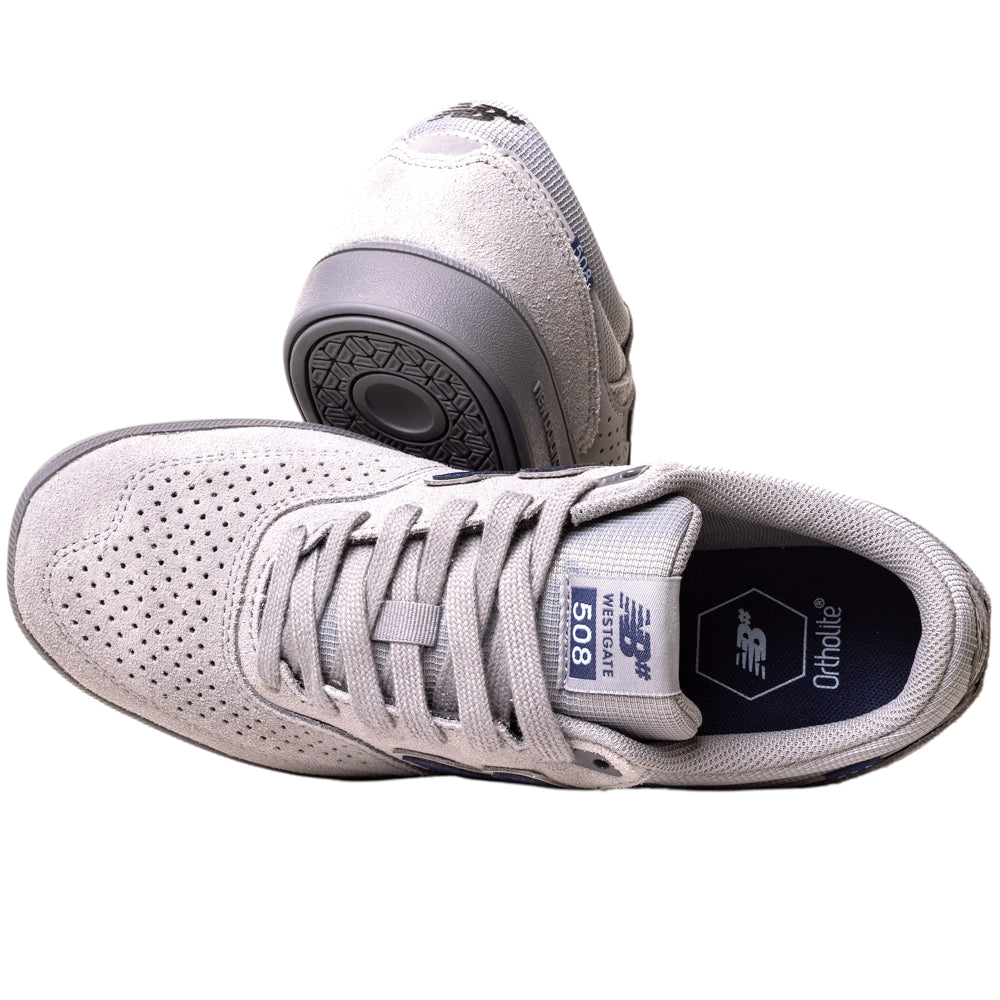 A pair of 508ICY Grey Navy New Balance Numeric suede skateboarding shoes, inspired by Brandon Westgate, with one shoe showing the top and the other the sole, featuring perforated details and visible laces.