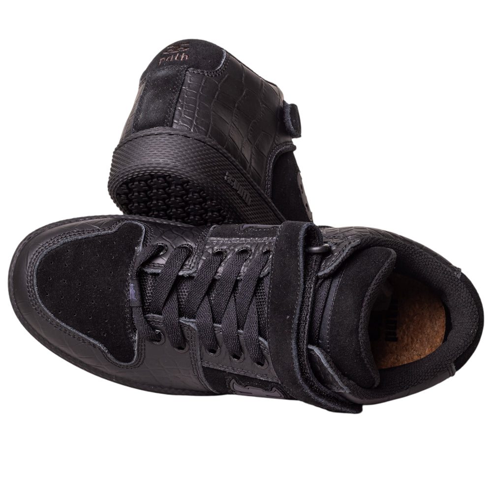 Two Grasshopper Black Croc Leather I Path Skateboarding shoes—one upright, one on its side—showcase a textured pattern, laces, Velcro strap, and visible sole treads, perfect for stylish everyday wear.