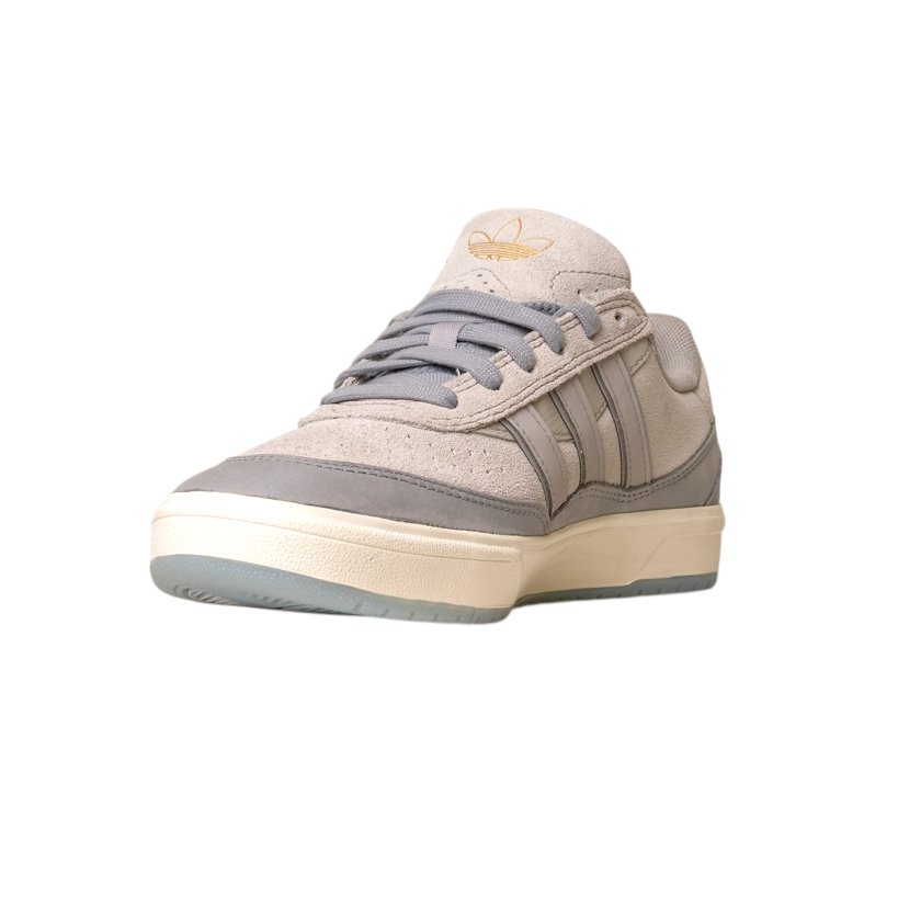 The JI0848 Granite White Tyshawn 2 Adidas Skateboarding Leather Suede Shoes feature a light sole and gold Adidas logo on the tongue, shown on a white background.