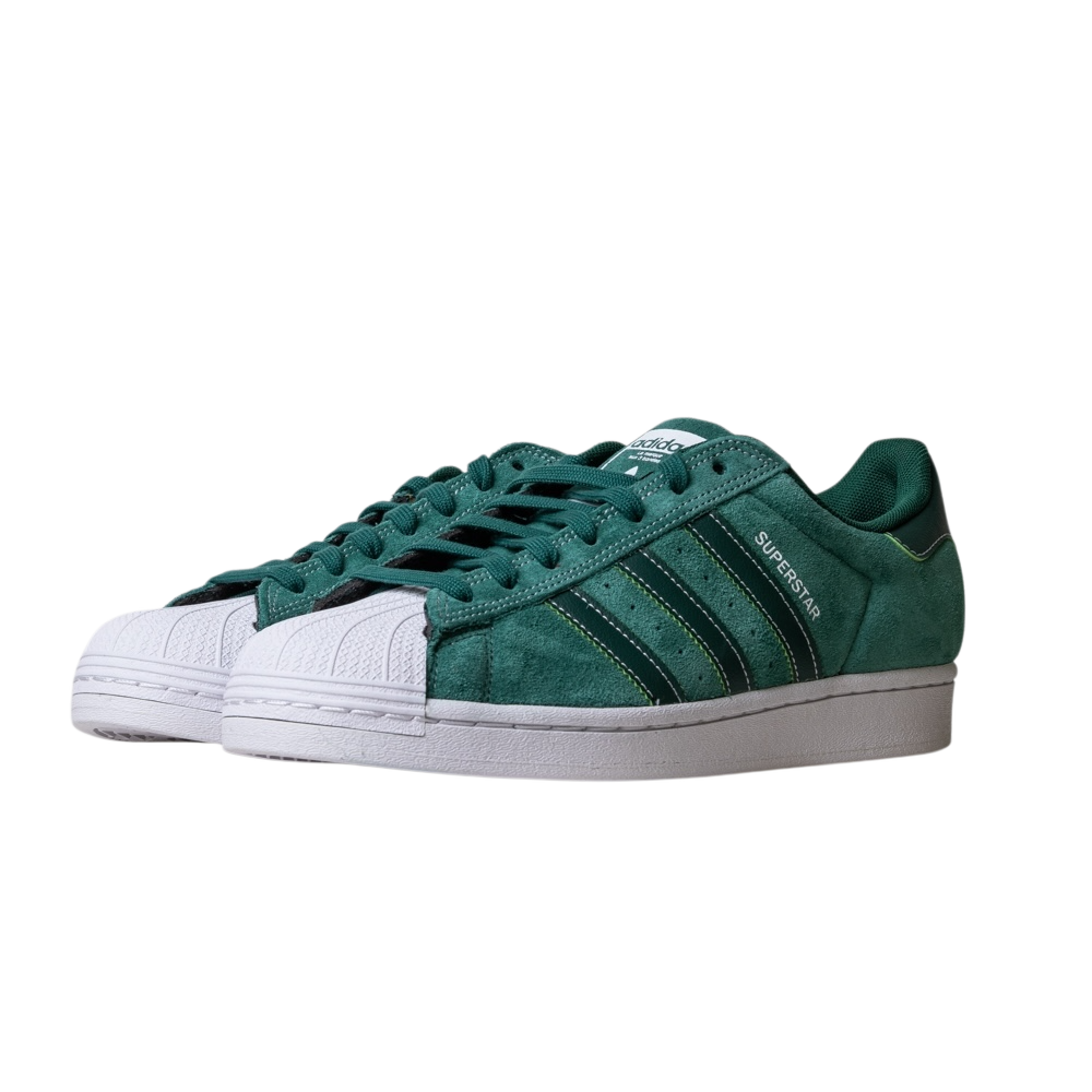 The JQ1103 Core Green White Superstar ADV Adidas Skateboarding Suede Shoes feature green suede uppers, classic white rubber shell toes, white midsoles, signature three stripes, and SUPERSTAR text on the side.