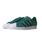 The JQ1103 Core Green White Superstar ADV Adidas Skateboarding Suede Shoes feature green suede uppers, classic white rubber shell toes, white midsoles, signature three stripes, and SUPERSTAR text on the side.