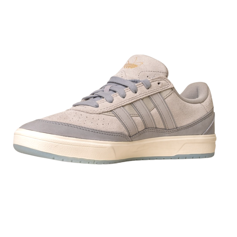 The JI0848 Granite White Tyshawn 2 II Adidas Skateboarding Shoes feature beige and gray leather and suede, signature three stripes, a gold logo on the tongue, gray laces, and a white sole—versatile skate shoes for any style.