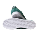 The JQ1103 Core Green White Superstar ADV Adidas Skateboarding suede shoes feature white stripes, a white sole with a zigzag tread for grip, and heel branding—shown from the side and bottom to highlight skate-friendly details.